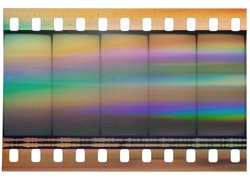 Beginning of 35mm cine filmstrip, first blank frames on white background, real scan of film material with cool scanning rainbow light interferences on the material.
