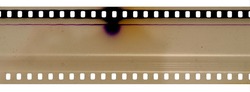 Part of 35mm cine filmstrip, first frames on white background, real scan of film material with cool scanning light interferences on the material.
