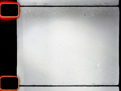 empty or blank 16mm film frame with black border and dust. film scan.