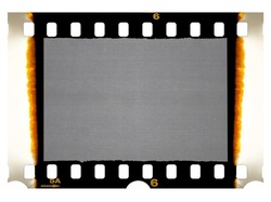 Old 35mm filmstrip or dia slide frame with burned edges isolated on white background. Real analog film scan with signs of usage.