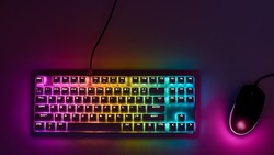 Gaming keyboard with RGB light. White mechanical keyboard and mouse with backlight. Colorful keyboard and mouse with RGB backlight. Gamer's Workspace
