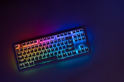 Gaming keyboard with RGB light. White mechanical keyboard. Gamer's workspace, neon light
