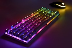 RGB gaming keyboard. Bright colorful keyboard with mouse, neon light. Mechanical keyboard with RGB light.