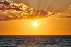 Yellow warm sun over deep blue sea at scenic sunset sky, picturesque view of horizon at sunset. Endless sea in warm bright sunlight at summer sunset. Beautiful calm seascape