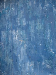 abstract close up design of shades of blue painted exterior wall faded blue paint on cement concrete wall of home weathered and old close up abstract background backdrop painted exterior wall fading 