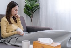 Asian woman sick at home. The woman had a cough, sore throat,runny nose and a high fever.