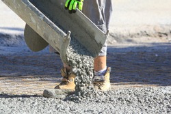 pouring wet concrete while paving a driveway