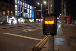 Photograph of the push button of a traffic light warning that you still have to wait to cross the street. Princess Street, Edinburgh, Scotland. 1-1-2020