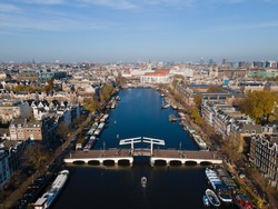 Amsterdam, The Netherlands, 7th November 2020 Aerial view of the Magere Brug Amsterdam And the river Amstel, City hall and Hermitage autumn