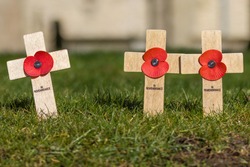Remembrance Day tributes of crosses and poppies, planted as a memorial to those who have lost their lives - Armistice Day, 100 year centenary since the end of The Great War, WW1