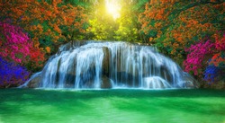 Waterfall in Thailand.View of erawan waterfall in deep forest which is full of various kinds of plants and morning sunshine at kanchanaburi province,Thailand. Selective focus.