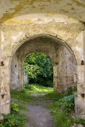 An unusual arched through passage into the rooms of an old ruined church. Copy space. Selective focus.