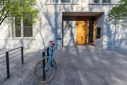 View to entrance door of a modern residential building with new apartments and bicycle stand in the city