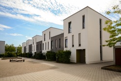 Modern townhouses in a residential area, new apartment buildings with green outdoor facilities in the city
