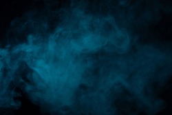 Blue smoke effect on a black background in a studio