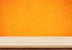 Empty wood table top on orange concrete background, Template mock up for display of product.
