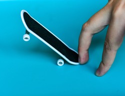 Child Hand playing  a fingerboard, close-up. Mini skate- fingerboard competitions, freestyle .