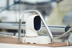 Details of stainless steel air intake on a teak deck of a luxury sailing yacht. Close-up of cowl ventilators for furnishing fresh air to compartments below deck of a boat.