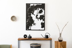 Stylish and cozy scandinavian interior of living room with wooden console, ring on the wall, cube, flowers and elegant personal accessories. Black mock up poster map. Design home decor. Template. 