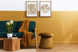 Stylish scandinavian interior of living room with design green velvet sofa, gold pouf, wooden furniture, cacti, carpet, cube, copy space and mock up poster frames. Template. 