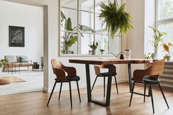 Stylish and botany interior of dining room with design craft wooden table, chairs, furniture, a lof of plants, window, poster map and elegant accessories in modern home decor. Template.