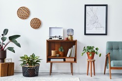 Retro composition of living room interior with mock up poster map, wooden shelf, book, armchair, plant, cacti, vinyl recorder, decoration and personal accessories in stylish home decor.