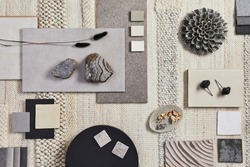 Flat lay design of creative architect moodboard composition with samples of building, beige textile and natural materials and personal accessories. Top view, template.
