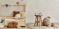 Stylish composition of cozy scandinavian child's room interior with wooden bed, toys and hanging decorations. Creative wall. Copy space. Template. 