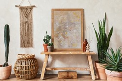Creative composition of stylish living room interior with mock up poster frame, wooden bench, rattan basket, cacti and boho accessories. Plant love and nature concept. Template.