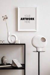 Stylish composition with mock up poster frame with black console, sculpture on the stand and personal accessories.
