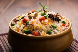 Indian Vegetable Pulav or Biryani made using Basmati Rice, served in a ceramic bowl. selective focus
