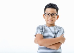 Cutout portrait of lovely young Asian healthy boy wearing glasses and casual horizontal striped shirt standing with arms crossed looks serious, confident, and determined