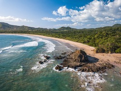 Playa Grande, Guanacaste, Costa Rica - Aerial View of most famous Surfer Beach with big Waves and Rocks - Tropical Landscape of Las Baulas Marine National Park