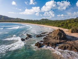 Playa Grande, Guanacaste, Costa Rica - Aerial Drone shot of large Tropical Beach with big Rocks - A Surfers Paradise