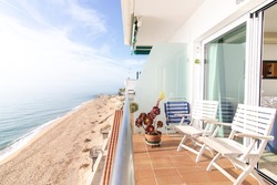 balcony with chairs by the sea