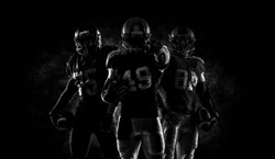 Proud american football players in dark