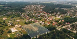 Marked vacant land for construction and sale. The concept of selling land and residential real estate on the land market is an aerial shot with overlay.