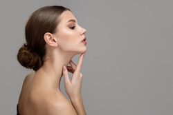 Woman face profile side view. Chin lift pointing with index finger