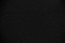 Water droplets on black background and texture.