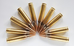 Cartridges with armor piercing bullets in a semi circle on a white background