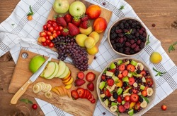
healthy mixed fruit salad (Blackberry, banana, peach, nectarine, strawberry, apple, apricot, grape, min) on a crockery bowl, a heap of summer fruits concept, healthy vitamins. organic.