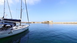 Sailboats moored at old harbor of Chania city, Crete, Greece.