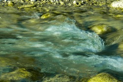 blurred motion of fresh flowing water of the rocky stream hdr image