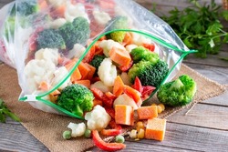 Frozen vegetables in plastic bags on a table. Frozen food
