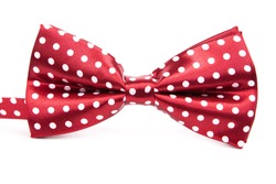 Elegant red bow tie with white polka dots on an isolated white background