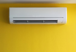 air conditioner on yellow wall