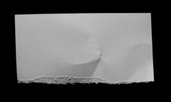 ripped sheet paper isolated on black background.