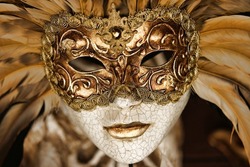 golden venetian mask with feathers