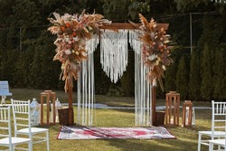 Beautiful unusual boho chic wedding arch for ceremony