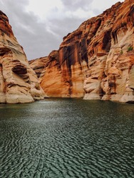 Lake Powell is a reservoir on the Colorado River, straddling the border between Utah and Arizona. Second largest man-made reservoir by maximum water capacity, created by the flooding of Glen Canyon.